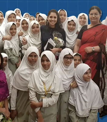 A diverse group of women wearing hijabs smiling and posing together