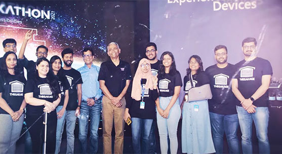 A large group of Microsoft's standing on a stage looking at the camera